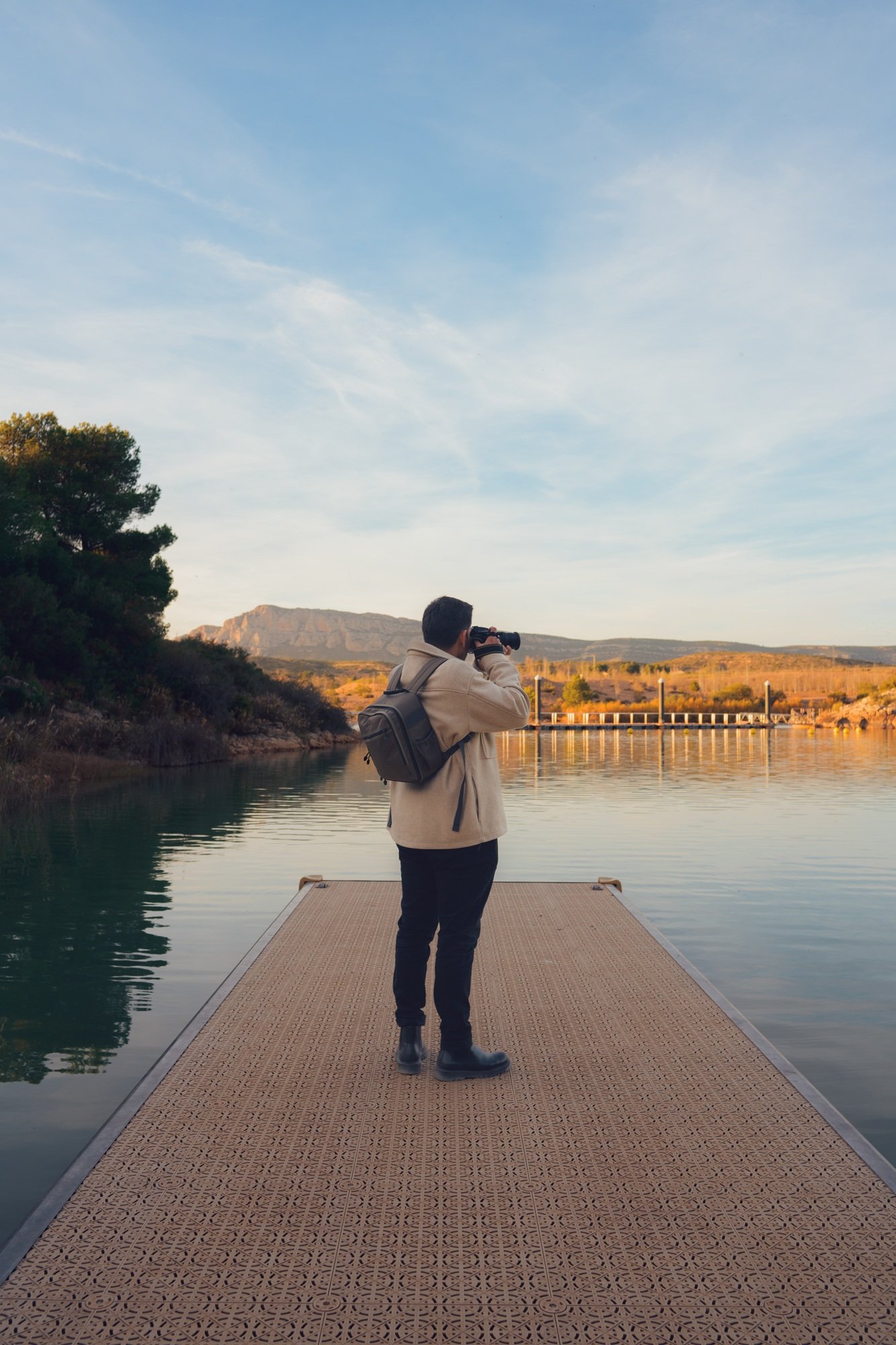 Latino Photographer Capturing Scenic Shots at a Lagoon