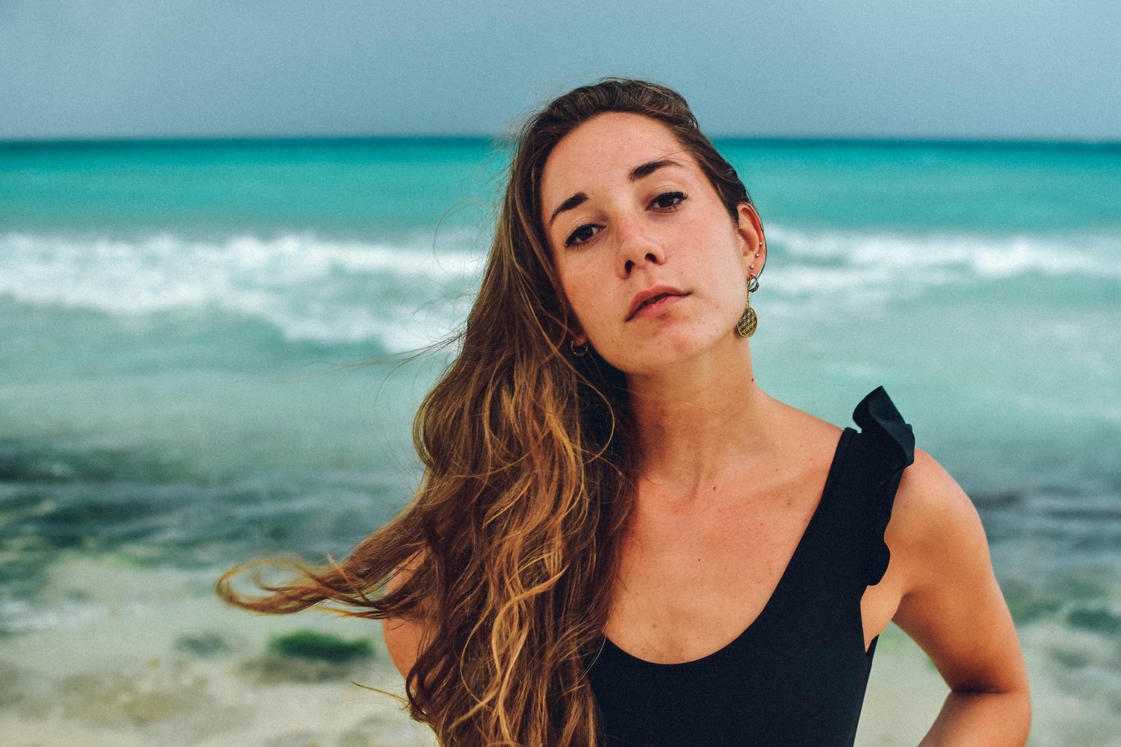 sexy latina girl posing in the caribbean beach of mexico